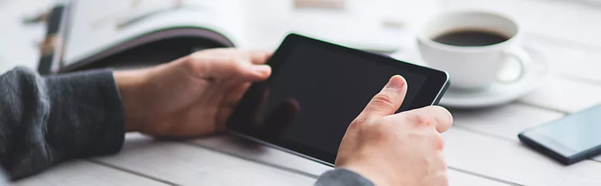 person on a black tablet with coffee