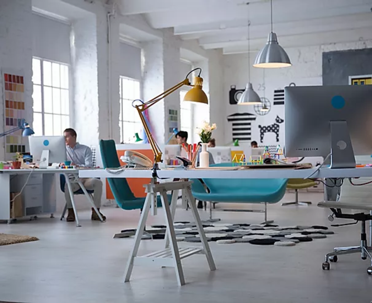 white themed office room desks chairs computers lights