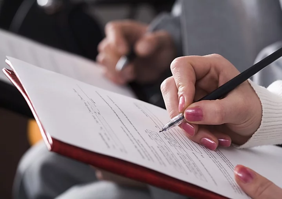 people writing with pens on paper