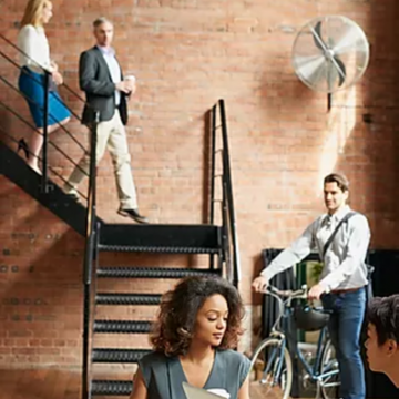 office staff walking down staircase bicycle