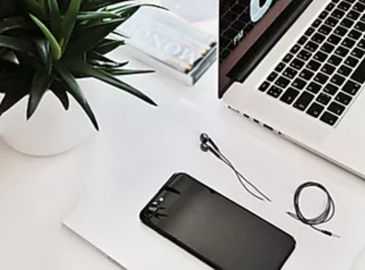 laptop headphones phone plant office desk